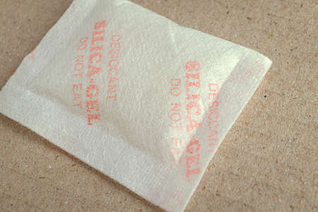 Close up silica gel or desiccant in paper bag backgroundの写真素材