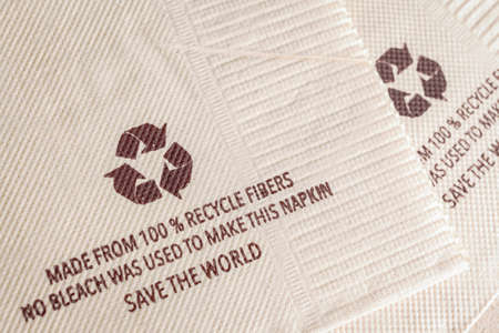 recycle sign on tissue paper made from 100% recycle fibers, no bleach was used to make this napkin, save the worldの写真素材