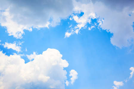 blue sky with cloud and sun rays backgroundの写真素材