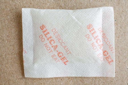 Close up silica gel or desiccant in paper bag backgroundの写真素材