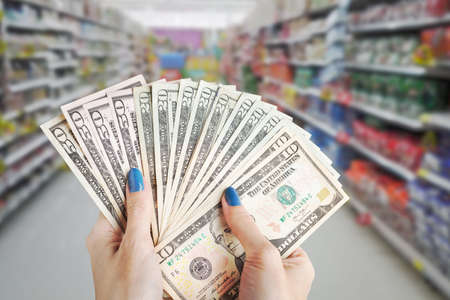 Money in the hand, Hand with money, Hand holding Banknotes and counting for give or pay bill, can use as financial or business department store and shopping mall backgroundの写真素材