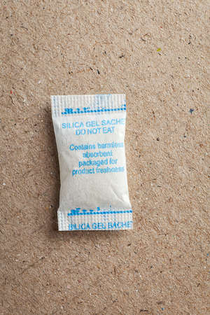 Close up silica gel or desiccant in paper bag backgroundの写真素材