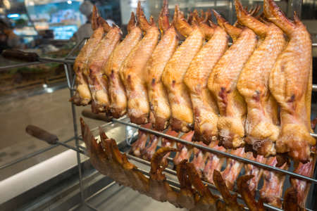 raw chicken wings on stainless stick rod for grillの写真素材