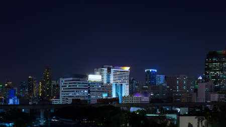 Business Building Bangkok city area at night life, panorama view shot, technology theme backgroundの写真素材