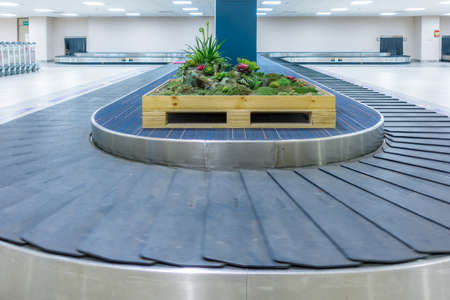 empty conveyor belt for carrying the passenger luggage or baggage claim at airportの写真素材