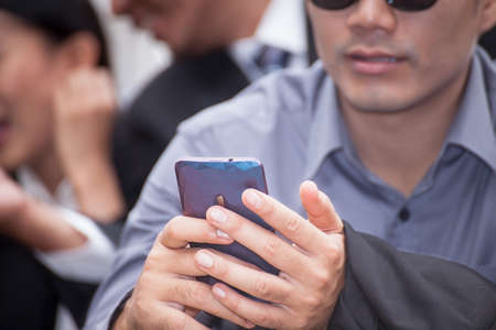 businessman using a cell phone close up shot background