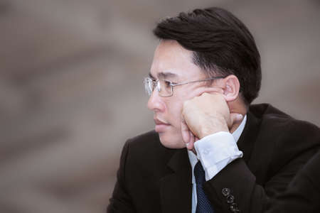 Asian business man thinking about job or his career path planing, business growth concept backgroundの写真素材