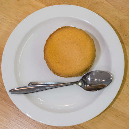 Sweet colorful french macaron or macaroons dessert on plate close up top view backgroundの写真素材