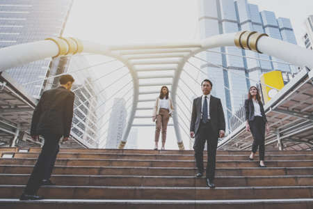 group of confident businessman going down and walking on stairs, vintage themeの写真素材