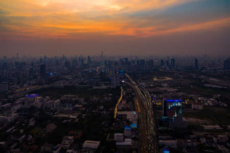 Aerial view of Bangkok city and traffic expressway with skyline at dusk twilight and fog or mist in bangkok cityscapeの写真素材