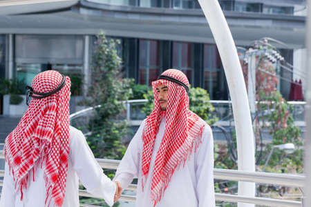 two arabian businessman shake hand and make decision together in modern cityの写真素材