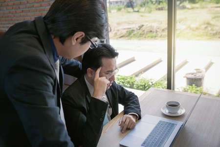 businessman coaching with boss and discussion thinking for working on notebook, working together as team concept backgroundの写真素材