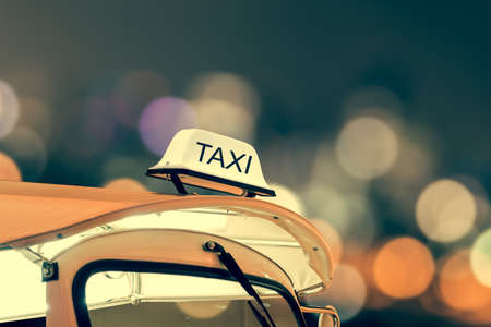 Taxi car on street and bokeh at night life, vintage themeの写真素材