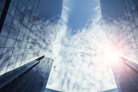 business cityscape modern building city and blue cloud sky urban area in low angle viewの写真素材