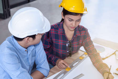 professional male and female engineers working and discuss with blueprint business plan together as teamworkの写真素材