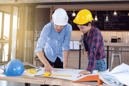 professional male and female engineers working and discuss with blueprint business together as teamworkの写真素材