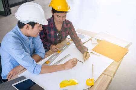 professional male and female engineers working and discuss with blueprint business plan together as teamworkの写真素材