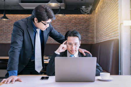 businessman coaching with boss and discussion thinking for working on notebook, working together as team concept backgroundの写真素材