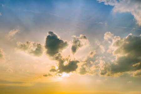 Sunlight and burst explode in cloudy blue sky clouds backgroundの写真素材