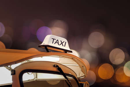 Taxi car on street and bokeh at night lifeの写真素材