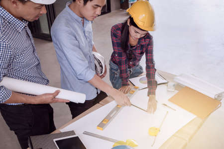professional male and female group of engineers working and discuss with blueprint business togetherの写真素材