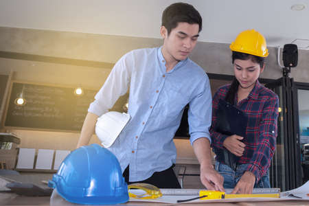 professional male and female engineers working and discuss with blueprint business togetherの写真素材
