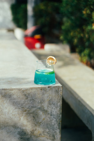 Blue cocktail with lemon on a stone terrace. Close up.の写真素材