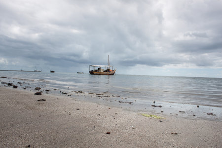 Fishing boat on the beach in cloudy weather, Trancoso, Bahiaの写真素材