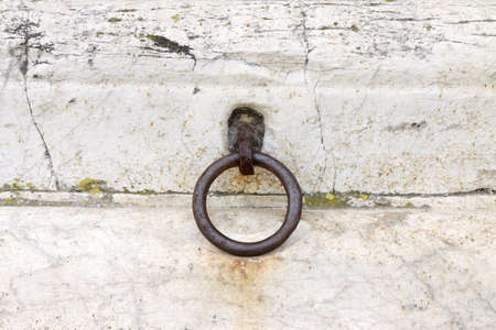 Metal ring placed in a stone wallの写真素材