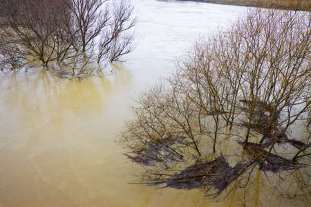 Raging waters and murky after torrential rainの写真素材