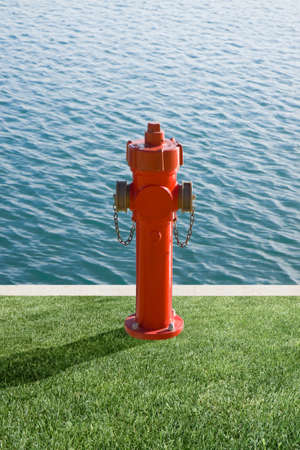 Plenty of water, concept image. Fire extinguisher on a harbor pier with copy spaceの写真素材