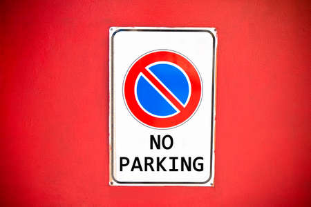No parking warning sign on red backgroundの写真素材