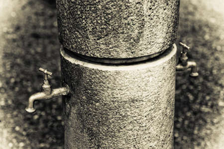 Drink Fountain in public garden - toned imageの写真素材