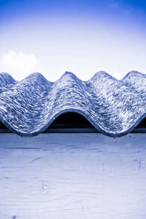 Detail of a dangerous asbestos roof - toned imageの写真素材