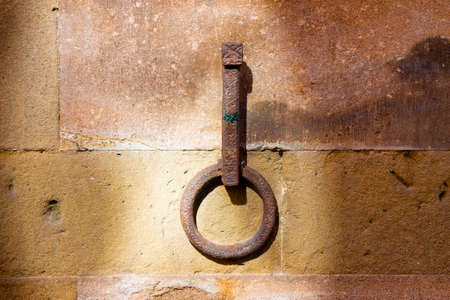 Old iron ring fixed to a stone wall - toned imageの写真素材