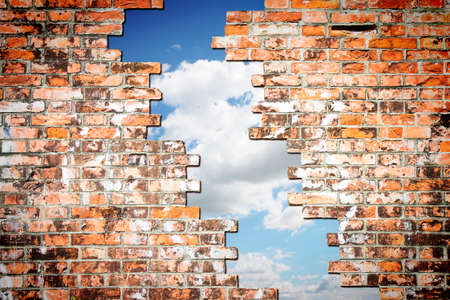 Through a crack of a brick wall you see the sky - concept imageの写真素材