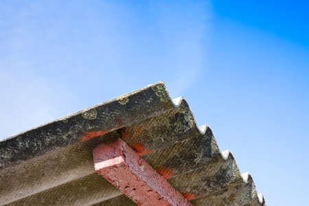 Dangerous asbestos roof - Medical studies have shown that the asbestos particles can cause cancerの写真素材