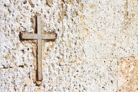 Iron cross snuggled in stone with copy spaceの写真素材