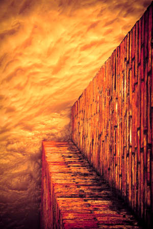 Brick wall for containing a water channel - toned imageの写真素材