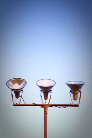 Three projectors of light against the sky background - concept image - toned imageの写真素材