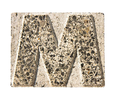 Letter M carved in a concrete block - A concrete block with the letter "M" carved into it.の写真素材