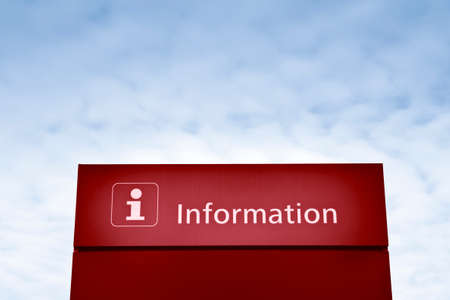 Red information sign against a blue sky - concept imageの写真素材