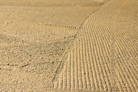 Plough agriculture field before sowing - Plowed field background