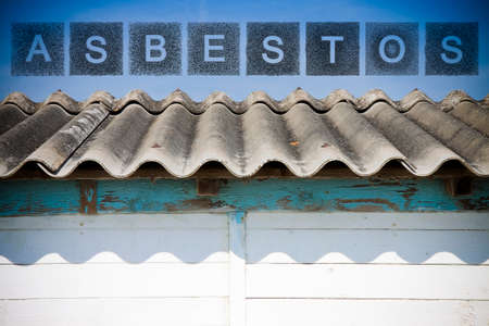 Dangerous asbestos roof. 
The word asbestos written with letters whose graphic resembles the shape of the asbestos particles.の写真素材