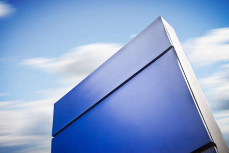 Blank blue information sign on sky backgroundの写真素材