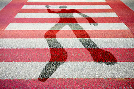 Silhouette of man drawn on a red and white paved road - concept imageの写真素材