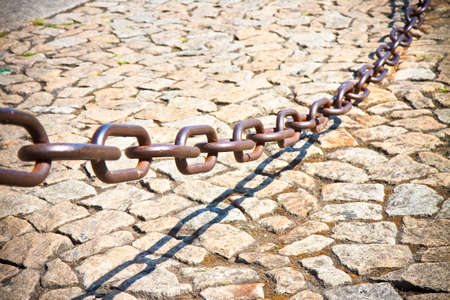 Metal chain that marks the city pedestrian areaの写真素材