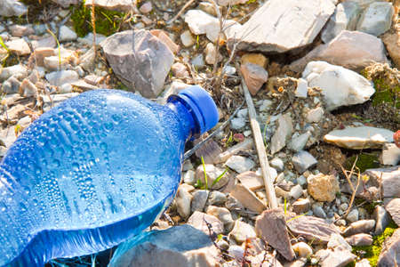 Abandoned blue plastic bottle - concept image