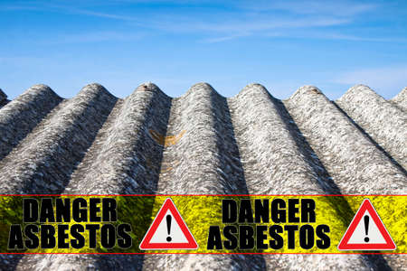 The message "danger asbestos" written on a yellow stripeの写真素材