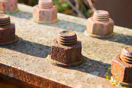 Old rusty anchor bolt with iron plateの写真素材